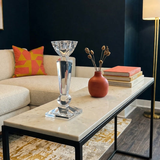 Modern living room with dark blue walls, a beige sofa, and decorative items on a coffee table.
