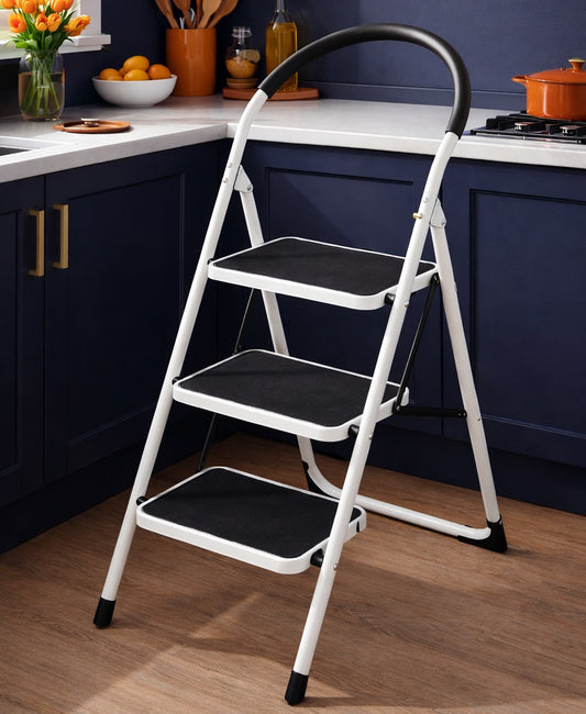 Step ladder in a kitchen setting with dark blue cabinets and a white countertop.