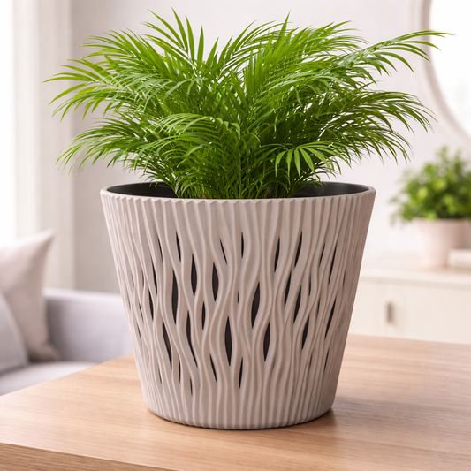 Potted plant in a decorative pot on a wooden table with a blurred indoor background