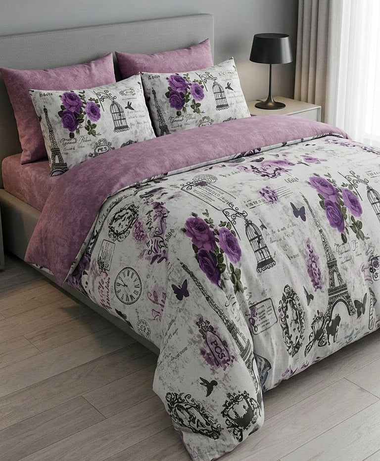 Bedding set with purple and gray design on a bed in a bedroom.
