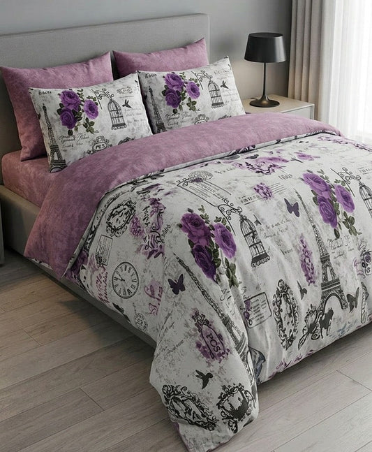 Bedding set with purple and gray design on a bed in a bedroom.