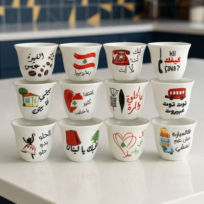 Set of small cups with various designs and text on a kitchen counter.