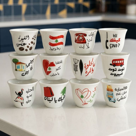 Set of small cups with various designs and text on a kitchen counter.