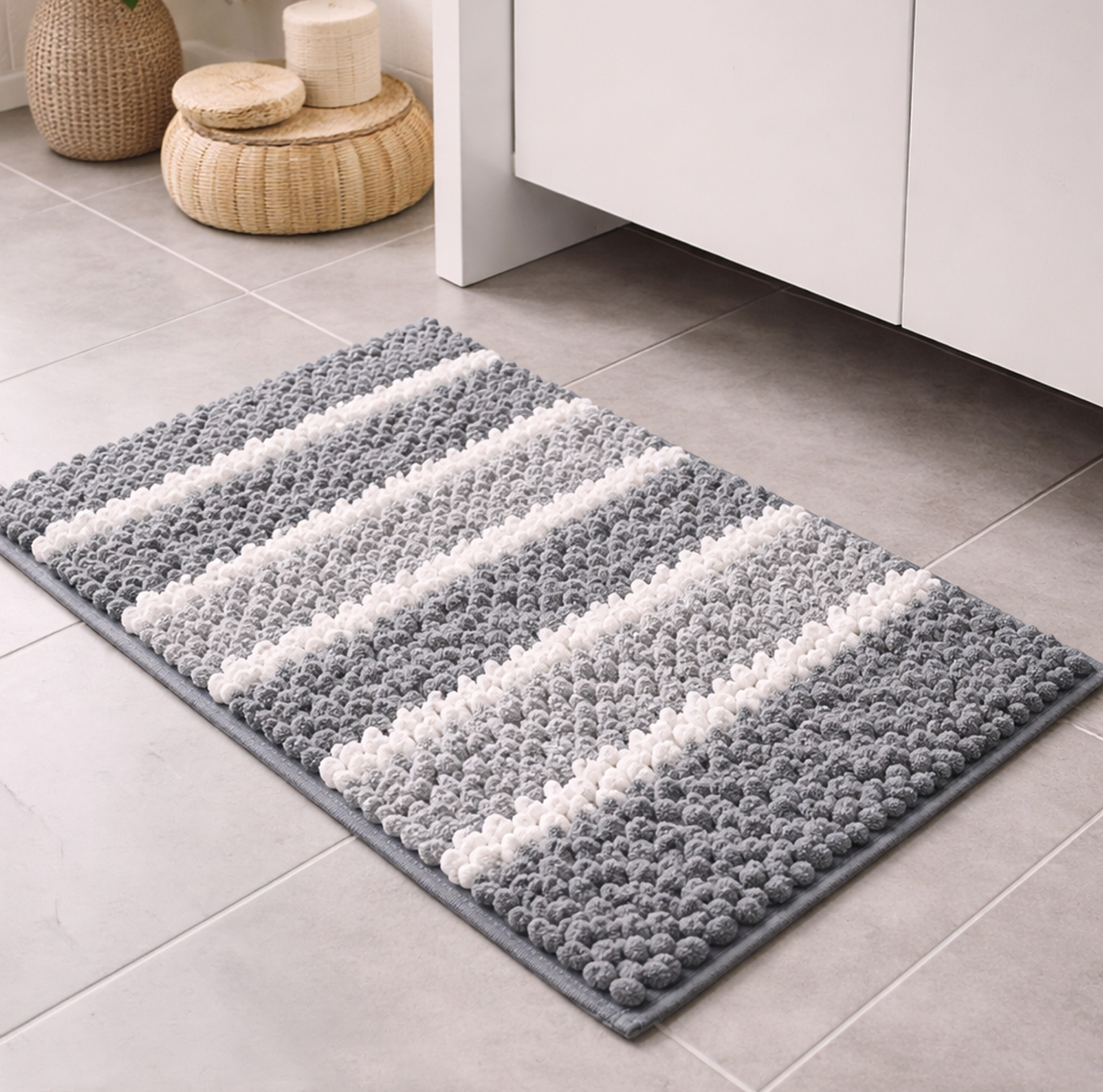Gray and white striped rug on a tiled floor with wicker stools in the background.