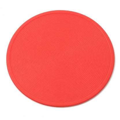 Round red placemat with textured surface on a white background