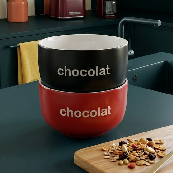 Modern kitchen with a red and white 'chocolat' mug on a counter.