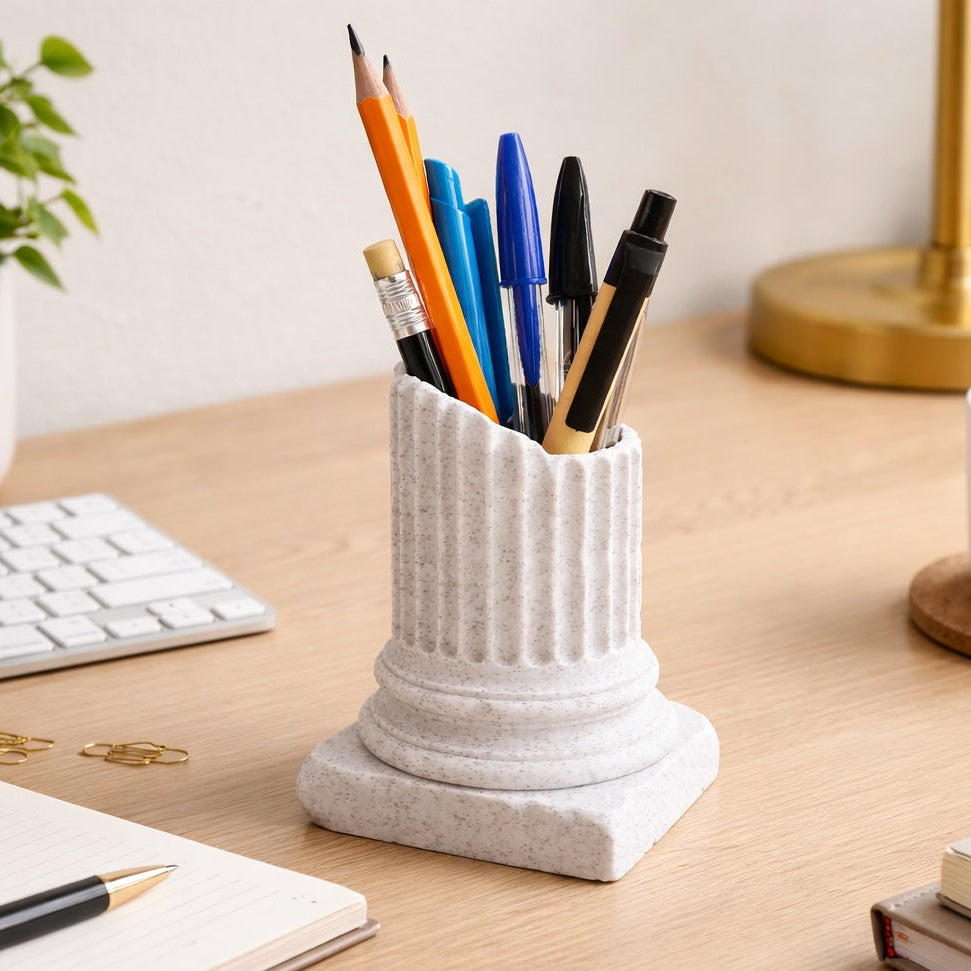 Desk setup with a pen holder containing pens, a cup of coffee, and office supplies.