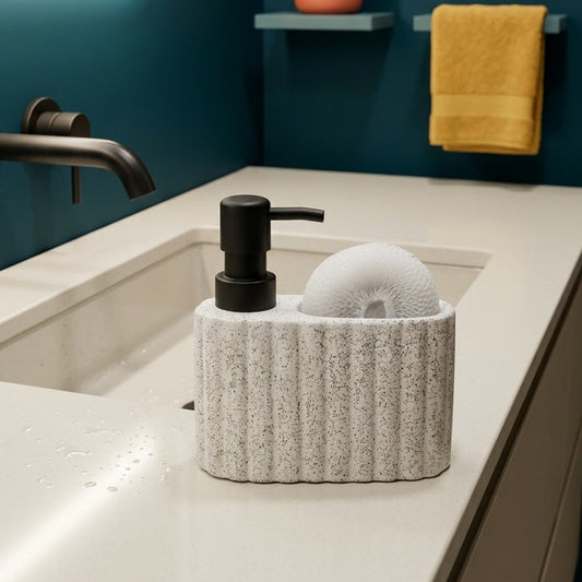 Bathroom counter with sink, soap dispenser, and decorative elements against a blue wall.