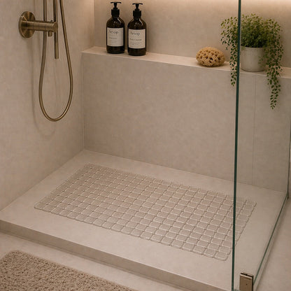 Modern shower with glass enclosure, tiled floor, and decorative elements.