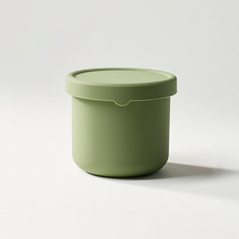 Green container with a lid on a white background