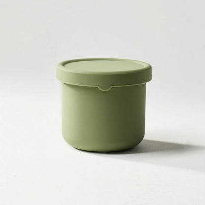 Green container with a lid on a white background