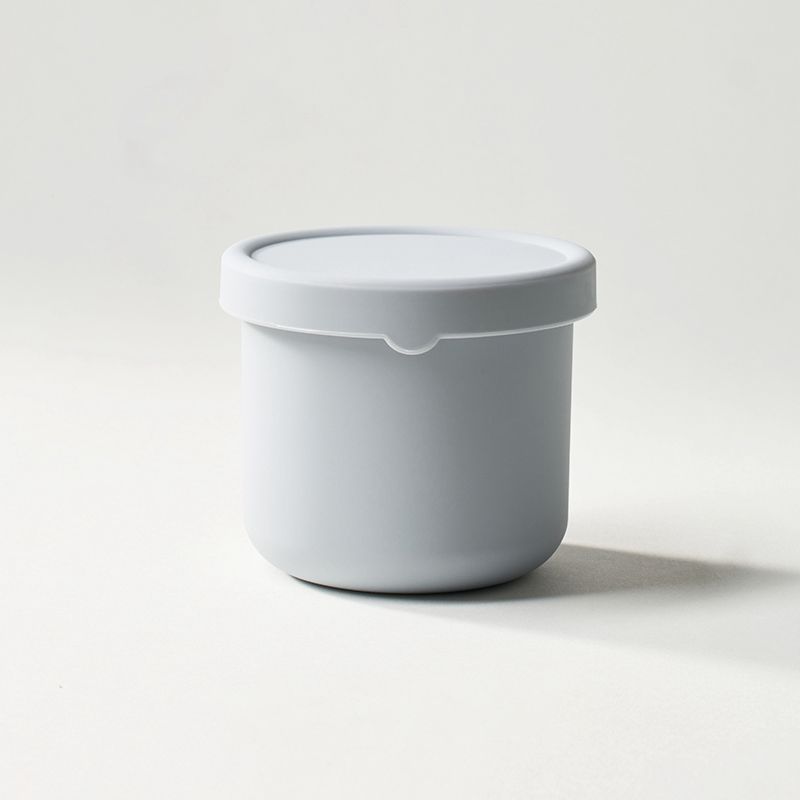White container with a lid on a light gray background